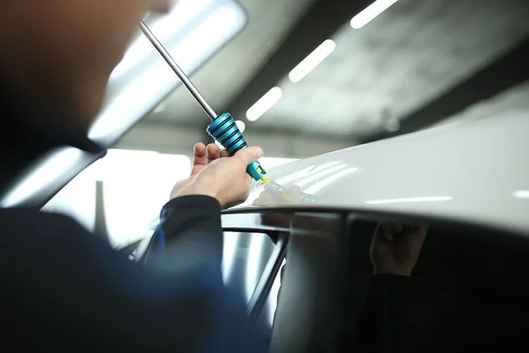 Paintless dent removal technician work